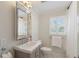 Well-lit bathroom with a decorative mirror over the sink and white marble floors at 733 Greenview Ne Ave, Atlanta, GA 30305
