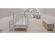 Bedroom with two white cribs and a small seating area under a window at 733 Greenview Ne Ave, Atlanta, GA 30305