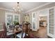 Bright dining room with chandelier, table set for eight, and french doors to the exterior at 733 Greenview Ne Ave, Atlanta, GA 30305