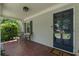 Inviting front porch with brick floor, seating, and stylish front door with house number at 733 Greenview Ne Ave, Atlanta, GA 30305