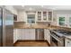 Modern kitchen with stainless steel appliances, white cabinetry, and granite countertops at 733 Greenview Ne Ave, Atlanta, GA 30305