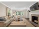 Spacious living room featuring a fireplace, large windows, and elegant furnishings at 733 Greenview Ne Ave, Atlanta, GA 30305