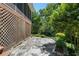 Stone patio is surrounded by lush greenery, offering a private and serene outdoor retreat at 733 Greenview Ne Ave, Atlanta, GA 30305