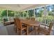 Spacious screened porch with wooden dining table and comfortable seating area at 733 Greenview Ne Ave, Atlanta, GA 30305