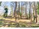 Spacious backyard with tall trees and ample space for outdoor activities at 870 Gaston Sw St, Atlanta, GA 30310