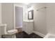 Well-lit bathroom with a white vanity, modern fixtures, and a toilet with coordinating black tiled flooring at 870 Gaston Sw St, Atlanta, GA 30310