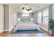 Primary bedroom with hardwood floors, neutral paint, ceiling fan, and views of the green yard at 870 Gaston Sw St, Atlanta, GA 30310