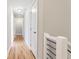 Well-lit hallway featuring hardwood floors and white doors with black hardware at 870 Gaston Sw St, Atlanta, GA 30310