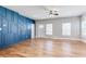 Spacious living room with beautiful hardwood floors, natural light, and a decorative blue wall at 870 Gaston Sw St, Atlanta, GA 30310