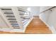 Modern staircase with wood treads, white risers, and a black metal railing at 870 Gaston Sw St, Atlanta, GA 30310