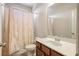 Bright bathroom featuring a shower with a decorative curtain and a vanity with dark wood cabinets at 218 Ballymore Lane Ln, Acworth, GA 30102