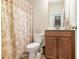 This bathroom includes a shower with curtain, toilet, vanity with sink and cabinet at 218 Ballymore Lane Ln, Acworth, GA 30102