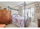 Cozy bedroom featuring a four-poster bed, wooden dresser, and bright natural light at 218 Ballymore Lane Ln, Acworth, GA 30102