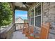 Cozy front porch featuring stone accents, rocking chairs, and a ceiling fan, perfect for relaxation at 218 Ballymore Lane Ln, Acworth, GA 30102