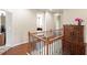 Hallway with hardwood floors, staircase, and an ornate wooden cabinet at 218 Ballymore Lane Ln, Acworth, GA 30102
