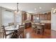 A kitchen and dining area with hardwood floors, stainless steel appliances and a door to the backyard at 218 Ballymore Lane Ln, Acworth, GA 30102