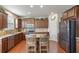 An open kitchen with a stainless steel refrigerator, a kitchen island, and hardwood floors at 218 Ballymore Lane Ln, Acworth, GA 30102