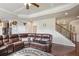 Spacious living room with coffered ceilings, a leather sofa, and a view of the staircase at 218 Ballymore Lane Ln, Acworth, GA 30102
