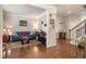 Cozy living room featuring hardwood floors, a blue sofa, and a staircase at 218 Ballymore Lane Ln, Acworth, GA 30102