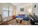 Comfortable living room with a blue sofa, hardwood floors, and a bright window at 218 Ballymore Lane Ln, Acworth, GA 30102