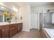 Main bathroom featuring double vanity, tiled floors, glass enclosed shower and soaking tub at 218 Ballymore Lane Ln, Acworth, GA 30102
