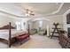 Main bedroom featuring a four-poster bed, sitting area, trey ceiling, carpet, and neutral colors at 218 Ballymore Lane Ln, Acworth, GA 30102