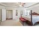 Main bedroom featuring a four-poster bed, trey ceiling, carpet, and ensuite bathroom at 218 Ballymore Lane Ln, Acworth, GA 30102