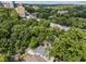 Aerial view showcasing the home nestled among lush trees with a city skyline backdrop at 28 Peachtree Hills Ne Ave, Atlanta, GA 30305
