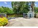 Spacious backyard area with a small blue building, patio area and surrounding greenery at 28 Peachtree Hills Ne Ave, Atlanta, GA 30305