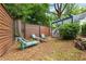 Private backyard with a fire pit, comfortable seating, and a charming pergola at 28 Peachtree Hills Ne Ave, Atlanta, GA 30305