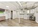 Finished basement with painted ceiling, modern washer, dryer, and stylish gray wood-look plank flooring at 28 Peachtree Hills Ne Ave, Atlanta, GA 30305