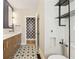 Well-designed bathroom with stylish vanity, decorative tile floor, and modern fixtures at 28 Peachtree Hills Ne Ave, Atlanta, GA 30305