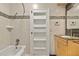 Elegant bathroom with stone accented tile and a built in storage cabinet at 28 Peachtree Hills Ne Ave, Atlanta, GA 30305