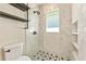 Modern shower with glass door, tiled walls, niche shelving, and stylish fixtures at 28 Peachtree Hills Ne Ave, Atlanta, GA 30305