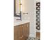 Vanity with stone countertop, modern faucet, decorative tile floor and bold wallpaper in adjacent room at 28 Peachtree Hills Ne Ave, Atlanta, GA 30305