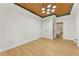 Large bedroom with hardwood floors, a tray ceiling, and an attached closet at 28 Peachtree Hills Ne Ave, Atlanta, GA 30305