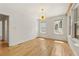 Bright bedroom featuring hardwood floors, white walls, and a modern light fixture at 28 Peachtree Hills Ne Ave, Atlanta, GA 30305