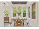 Elegant dining room with hardwood floors, stylish table, and ample natural light from large windows at 28 Peachtree Hills Ne Ave, Atlanta, GA 30305