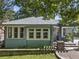 Charming exterior of a single-story home with gray brick and mature trees at 28 Peachtree Hills Ne Ave, Atlanta, GA 30305