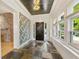 Elegant foyer with stone floors, decorative wallpaper, and natural light streaming through windows at 28 Peachtree Hills Ne Ave, Atlanta, GA 30305