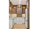 Well-organized kitchen featuring wood cabinets, white lower cabinets, and sleek, modern appliances at 28 Peachtree Hills Ne Ave, Atlanta, GA 30305