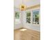 Bright and airy living room featuring hardwood floors, large windows, and stylish light fixture at 28 Peachtree Hills Ne Ave, Atlanta, GA 30305