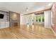 Spacious open-concept living area with hardwood floors, fireplace, and a view into the sunroom at 28 Peachtree Hills Ne Ave, Atlanta, GA 30305