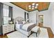 Luxurious main bedroom with stylish decor, a tray ceiling, and a comfortable seating area at 28 Peachtree Hills Ne Ave, Atlanta, GA 30305