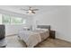 Bedroom with wood floors, a ceiling fan, and a bright window overlooking the yard at 3236 Henderson Mill Rd # 1, Chamblee, GA 30341