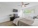 Bright bedroom featuring wood flooring, a ceiling fan, and a large window offering ample natural light at 3236 Henderson Mill Rd # 1, Chamblee, GA 30341