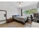 Well-lit bedroom with wood floors, a desk, and a window view of the outdoors at 3236 Henderson Mill Rd # 1, Chamblee, GA 30341