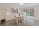 Bright dining area with stylish hardwood floors, contemporary table set, and a sliding glass door at 3236 Henderson Mill Rd # 1, Chamblee, GA 30341