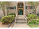 Welcoming condo entrance with arched doorway, lush plantings, and classic architectural charm at 3236 Henderson Mill Rd # 1, Chamblee, GA 30341