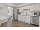Modern kitchen with stainless steel appliances, white cabinets, and contrasting gold hardware at 3236 Henderson Mill Rd # 1, Chamblee, GA 30341